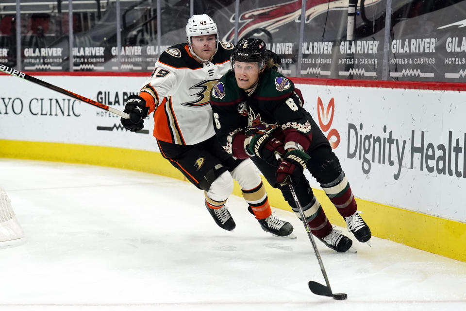 Arizona Coyotes defenseman Jakob Chychrun (6) shields the puck from Anaheim Ducks left wing, Max Jones, in the first period during an NHL hockey game, Monday, Feb. 22, 2021, in Glendale, Ariz. (AP Photo/Rick Scuteri)