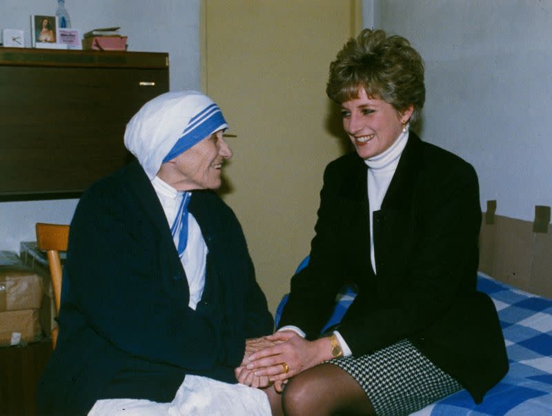 FILE PHOTO: Britain's Princess Diana holds the hands of Mother Teresa of Calcutta during their first meeting at the Missionary Sisters of Charity residence in Rome