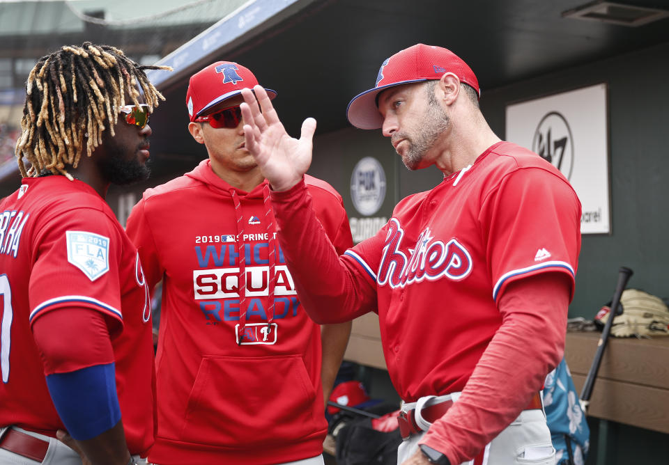 Philadelphia Phillies center fielder Odubel Herrera, left, and Philadelphia Phillies manager Gabe Kapler, right, talk in the dugout in the fourth inning during an exhibition spring training baseball game against the St. Louis Cardinals on Monday, March 18, 2019, in Jupiter, Fla. (AP Photo/Brynn Anderson)
