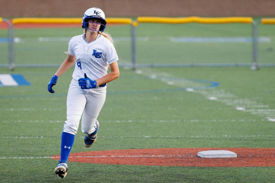 Lexington Catholic’s Lydia Kennedy (8) rounds the bases after hitting a home run in the 43rd District finals.