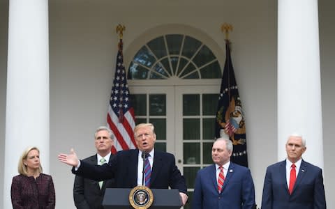 Donald Trump, with (L-R) Secretary of Homeland Security Kirstjen Nielsen, US Representative Kevin McCarthy, Representative Steve Scalise, and Vice President Mike Pence, speaks at a press conference in the Rose Garden of the White House - Credit: SAUL LOEB / AFP