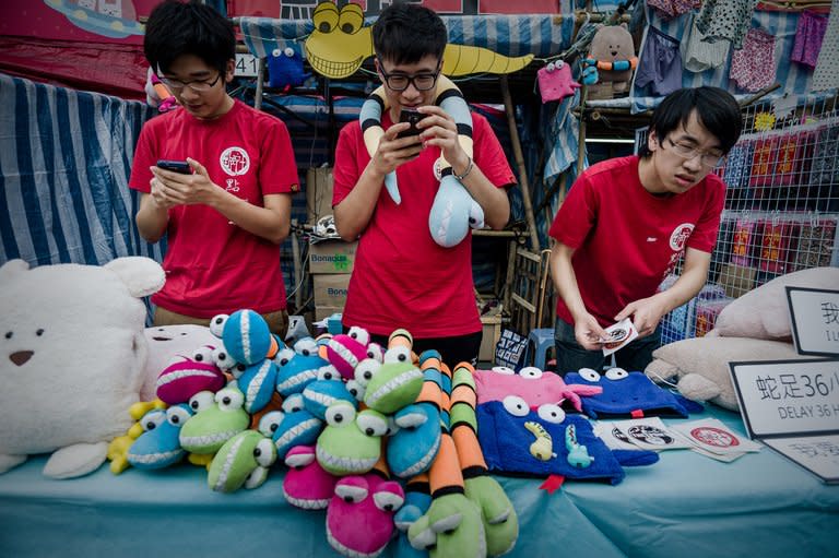 Young sales assistants are seen at a stall of a Chinese New Year fair in Hong Kong, on February 5, 2013. The Lunar New Year will mark the year of the snake on February 10