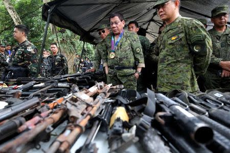 Philippine President Rodrigo Duterte inspects firearms together with Eduardo Ano, Chief of Staff of the Armed Forces of the Philippines (AFP), during his visit at the military camp in Marawi city, southern Philippines July 20, 2017. Malacanang Presidential Palace/Handout via Reuters