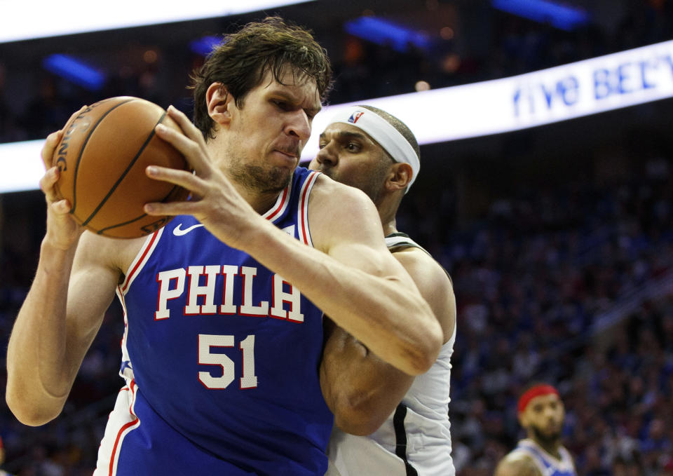 Philadelphia 76ers' Boban Marjanovic, left, of Serbia, makes a move against Brooklyn Nets' Jared Dudley, right, during the first half in Game 1 of a first-round NBA basketball playoff series, Saturday, April 13, 2019, in Philadelphia. (AP Photo/Chris Szagola)