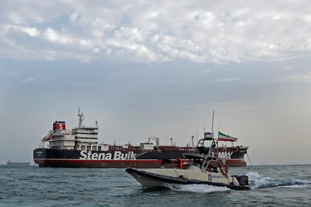 A boat of Iranian Revolutionary Guard sails next to Stena Impero, a British-flagged vessel owned by Stena Bulk, at Bandar Abbas port