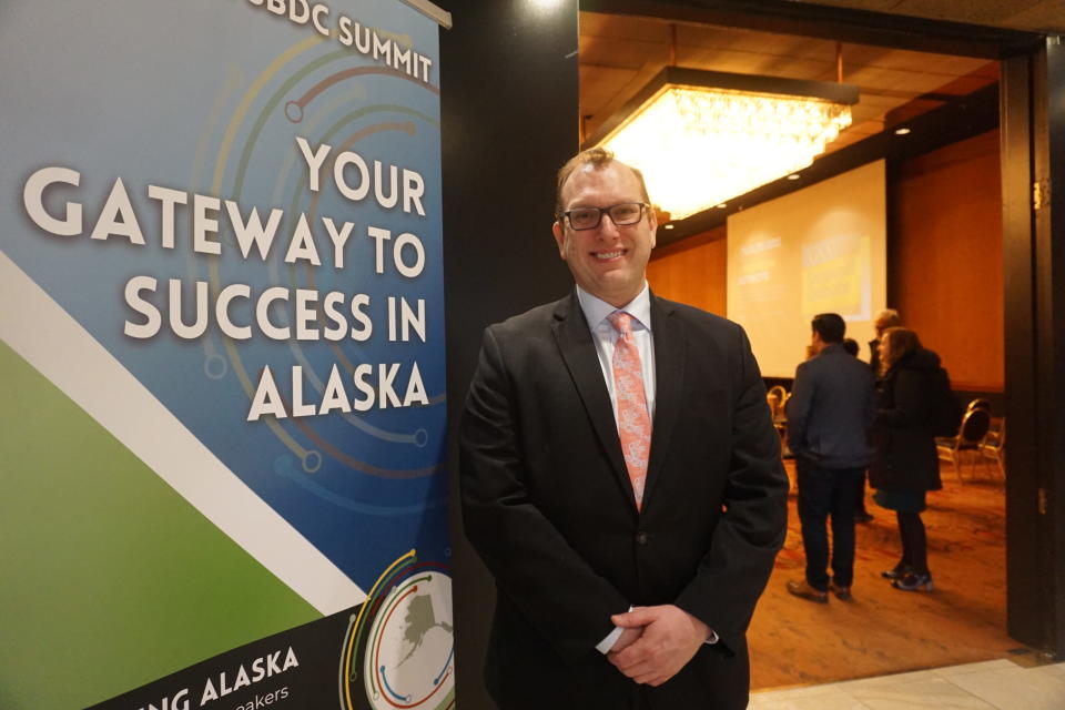 John Bittner, executive director of the Alaska Small Business Development Center, stands outside a meeting room at Anchorage's Hotel Captain Cook during a break in the organization's March 4 conference on artificial intelligence. (Photo by Yereth Rosen)