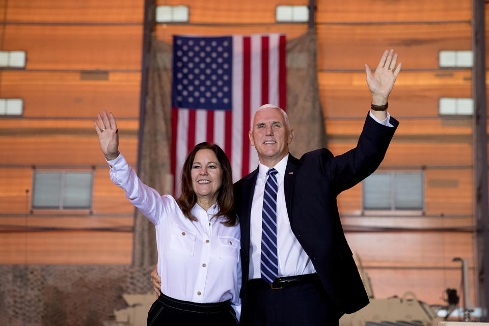 Vice President Mike Pence and his wife Karen Pence wave as they take the stage to speak to troops at Al Asad Air Base, Iraq, Saturday, Nov. 23, 2019. The visit is Pence’s first to Iraq and comes nearly one year since President Donald Trump’s surprise visit to the country. (AP Photo/Andrew Harnik)