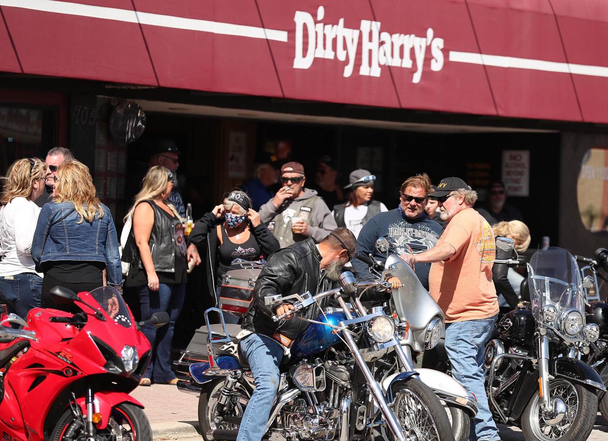 Bikers gather in front of Dirty Harry’s bar on Main Street during Bike Week in Daytona Beach on Monday, March 8, 2021. (Stephen M. Dowell/Orlando Sentinel)