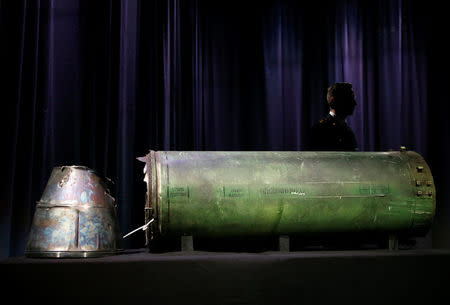 A damaged missile is displayed during a news conference by members of the Joint Investigation Team, comprising the authorities from Australia, Belgium, Malaysia, the Netherlands and Ukraine who present interim results in the ongoing investigation of the 2014 MH17 crash that killed 298 people over eastern Ukraine, in Bunnik, Netherlands, May 24, 2018. REUTERS/Francois Lenoir