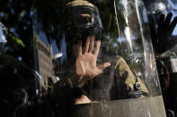 An officer holds their hand on a riot shield as demonstrators gather to protest the death of George Floyd, Monday, June 1, 2020, near the White House in Washington. Floyd died after being restrained by Minneapolis police officers. (AP Photo/Evan Vucci)