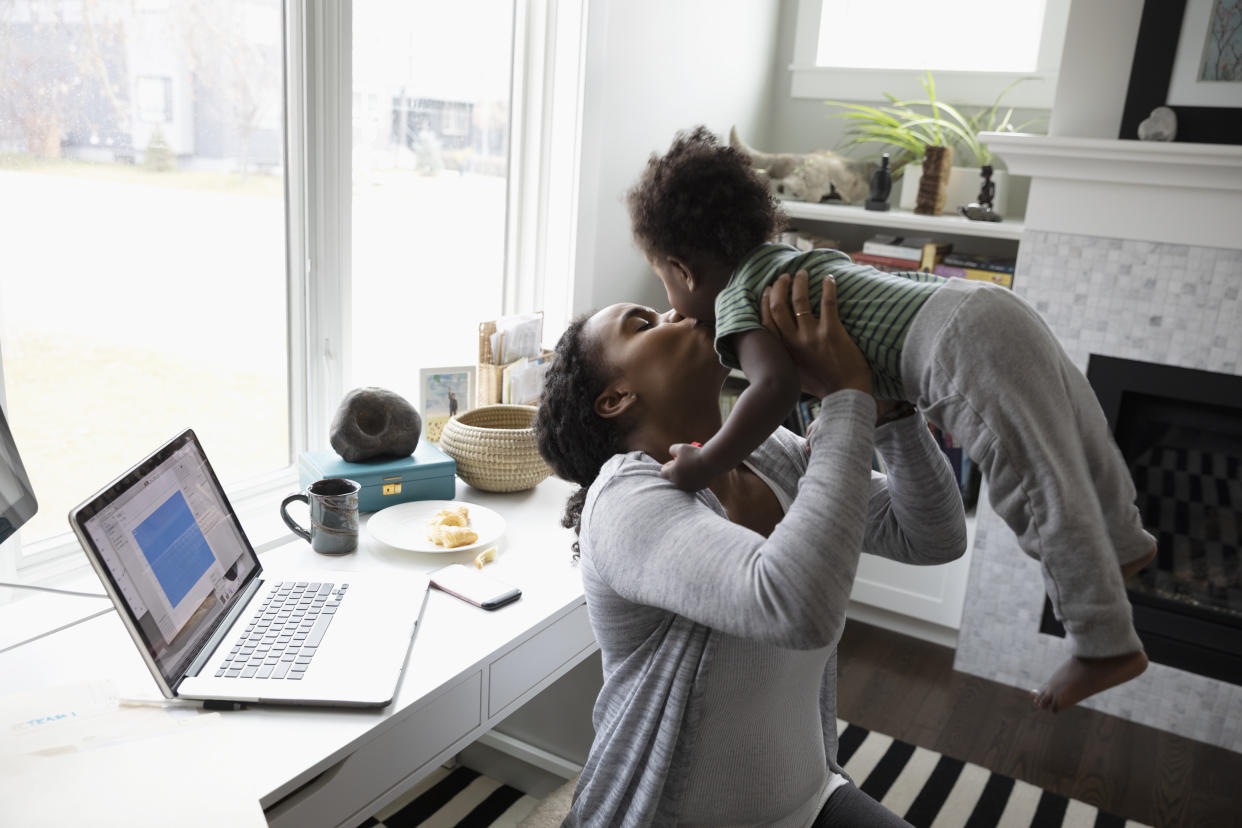 Affectionate mother kissing toddler son