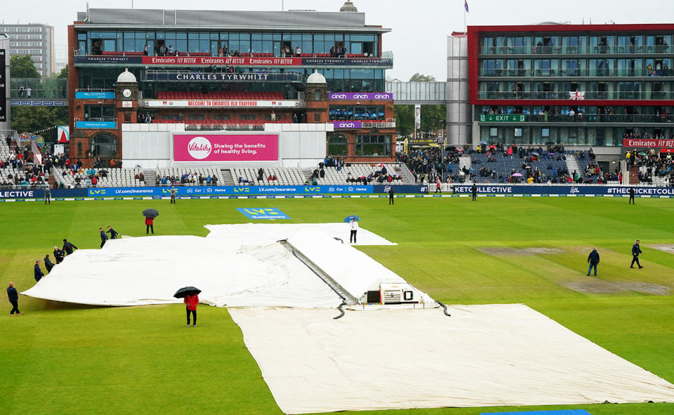 Covers on the pitch during the fourth day of the fourth Ashes Test at Old Trafford.