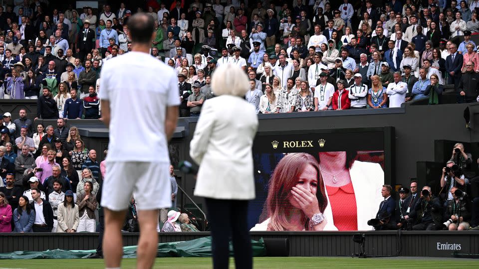Murray watches on as a video montage of his career highlights plays on the big screens at Wimbledon. - Mike Hewitt/Getty Images