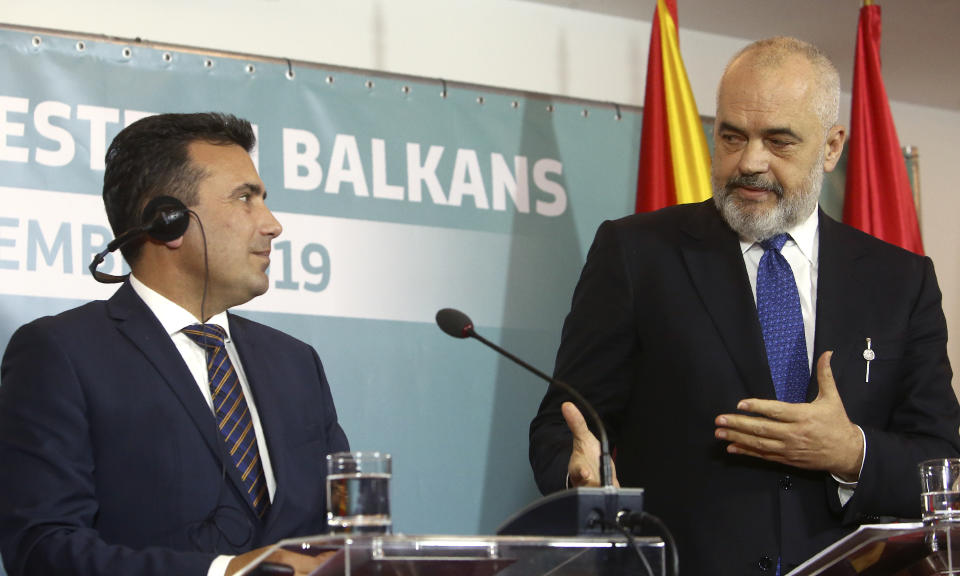 North Macedonia's Prime Minister Zoran Zaev, center and Albania's Prime Minister Edi Rama, right, look at each other during a joint news conference, following the Western Balkan leaders' meeting in the southwestern town of Ohrid, North Macedonia, Sunday, Nov. 10, 2019. Western Balkan leaders say they are committed to work closely and to remove administrative barriers for free movement of goods and people between their countries. (AP Photo/Boris Grdanoski)