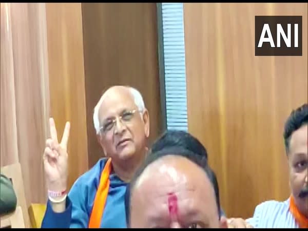 BJP MLA Bhupendra Patel was seen showing a victory sign during the announcement of the new CM of Gujarat at the party office in Gandhinagar (Photo/ANI)