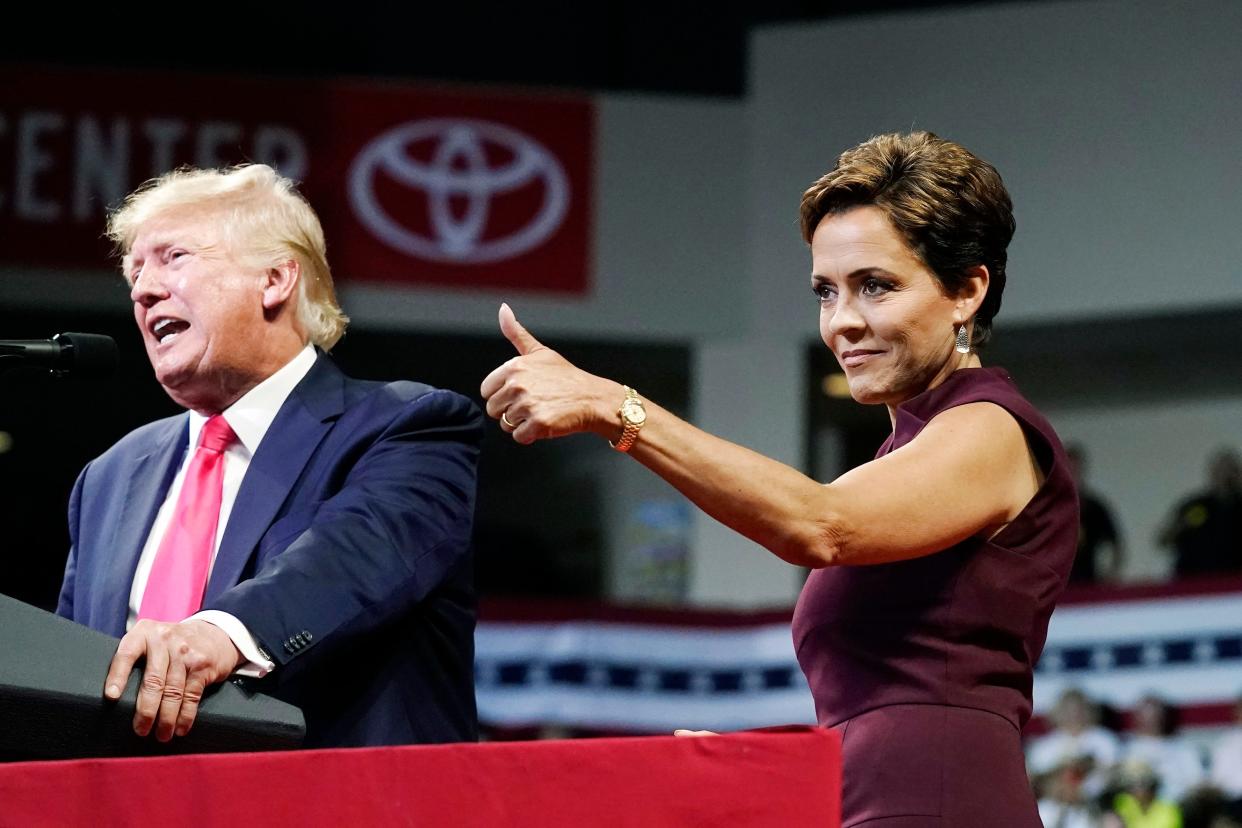 Arizona Republican candidate for governor Kari Lake gives a thumbs-up to the crowd as former President Donald Trump speaks at a Save America rally on  July 22, 2022, in Prescott.