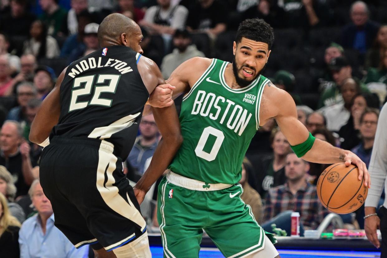 Boston Celtics forward Jayson Tatum (0) drives past Milwaukee Bucks forward Khris Middleton (22) in the third quarter at Fiserv Forum.