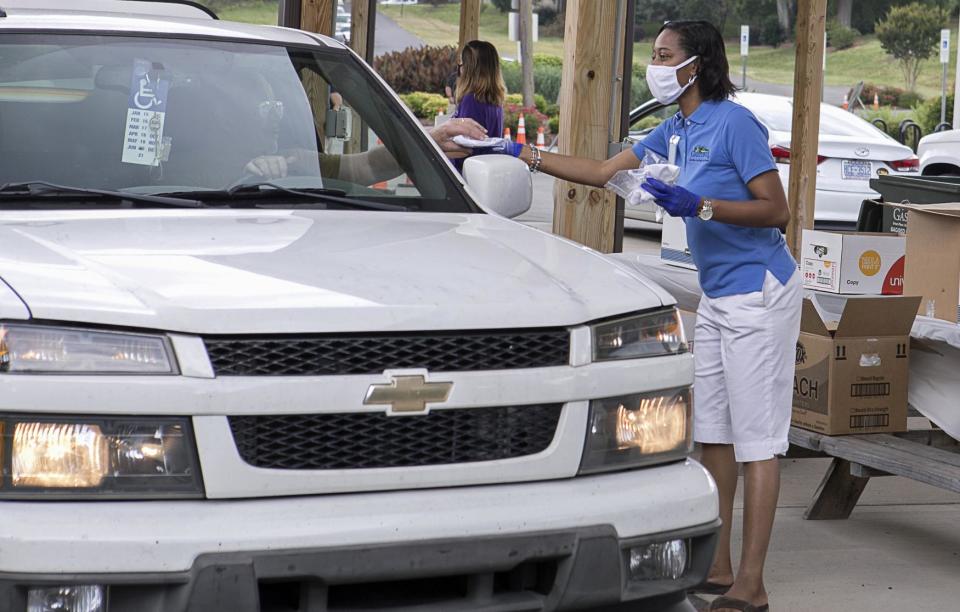 Gastonia Councilwoman Donyel Barber, hands out free face mask to help slow the spread of COVID-19, at an earlier mask giveaway at the Gastonia Farmers Market.