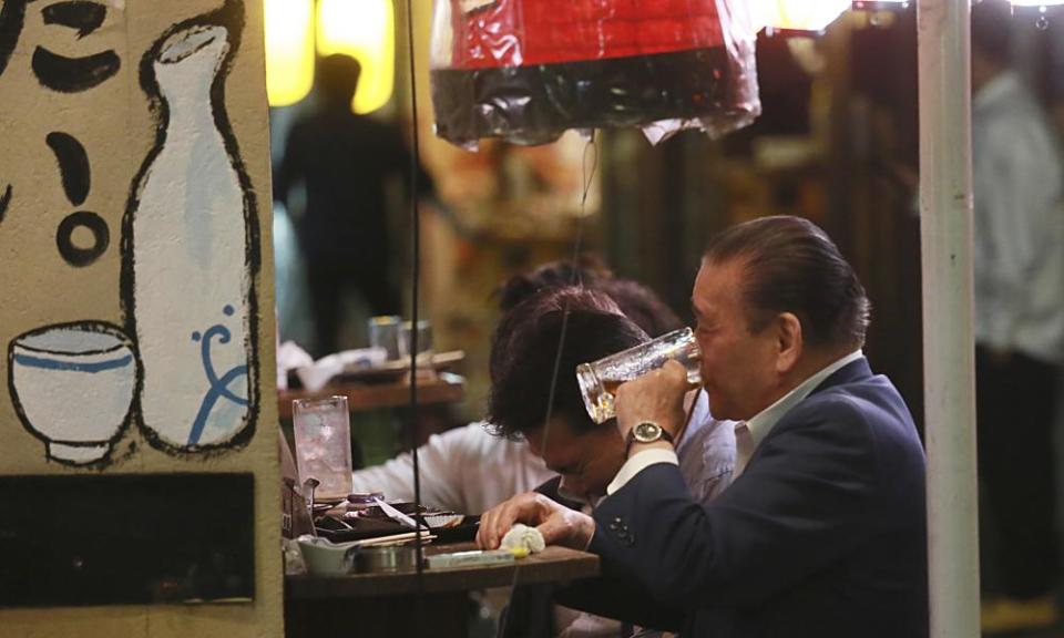 Man drinks at a bar in Tokyo