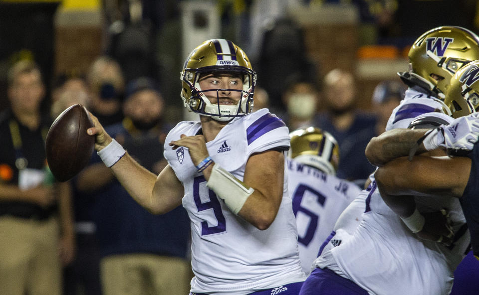 Washington quarterback Dylan Morris (9) throws a pass in the second quarter of an NCAA college football game against Michigan in Ann Arbor, Mich., Saturday, Sept. 11, 2021. (AP Photo/Tony Ding)