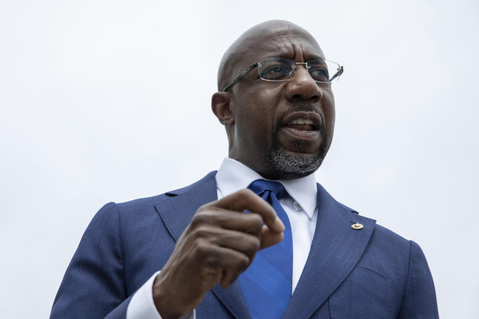 FILE - In this Aug, 3, 2021, file photo Sen. Raphael Warnock, D-Ga., speaks to reporters about voting rights legislation on Capitol Hill in Washington. Herschel Walker is the odds-on favorite to win the primary where he is vying for a chance to unseat Democratic Sen. Raphael Warnock in 2022, the state's first Black senator. (AP Photo/Amanda Andrade-Rhoades, File)