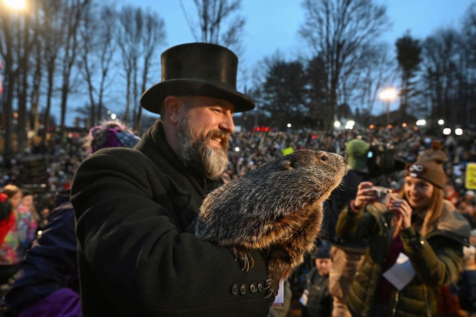 Groundhog Club handler A.J. Dereume holds Punxsutawney Phil, the weather prognosticating groundhog, during the 138th celebration of Groundhog Day on Gobbler's Knob in Punxsutawney, Pa., Friday, Feb. 2, 2024. Phil's handlers said that the groundhog has forecast an early spring.