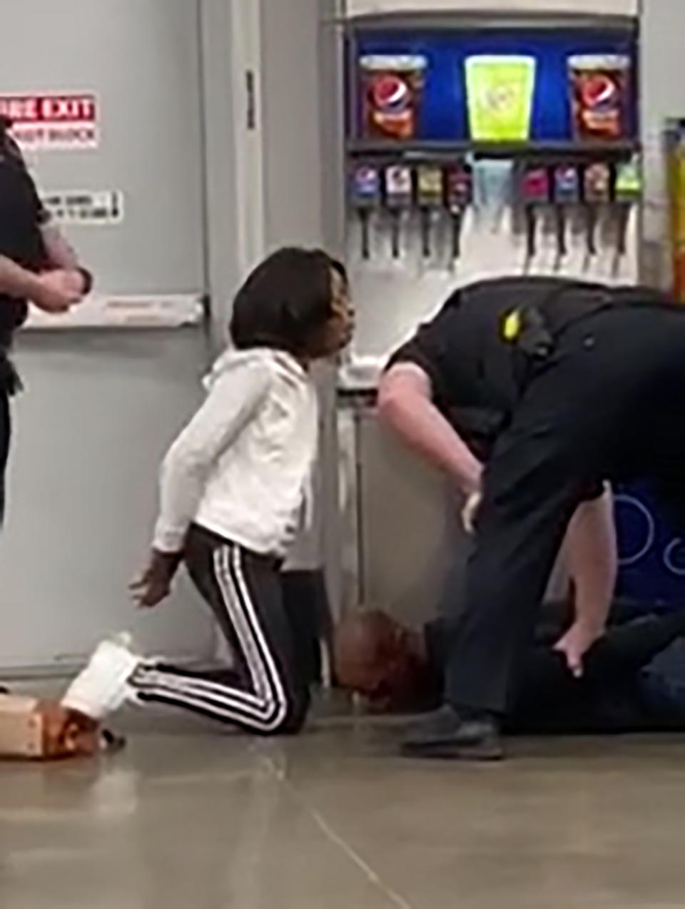 FILE - In this March 23, 2020, file frame grab taken from video, Marvia Gray, left and her son Derek Gray are arrested by white police officers at a Sam's Club store in Des Peres, Missouri. St. Louis County’s prosecutor launched of an investigation Wednesday, May 20, 2020, after video showed white police officers forcefully arresting Gray and her son Derek. (Photo courtesy Action Injury Law Group via AP, File)