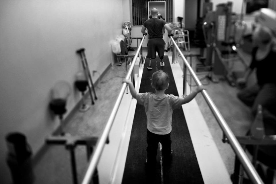 Liam, 2, accompanies his dad, Jake Romo, during rehab at the Naval Medical Center in San Diego. Romo, 22, lost both his legs while serving with the 3rd Battalion, 5th Marines, in Sangin, Afghanistan. <i>From the story "<a href="http://www.npr.org/2011/11/04/141988965/for-wounded-marines-the-long-hard-road-of-rehab" target="_blank">For Wounded Marines, The Long, Hard Road Of Rehab</a>,"&nbsp;2011.</i>