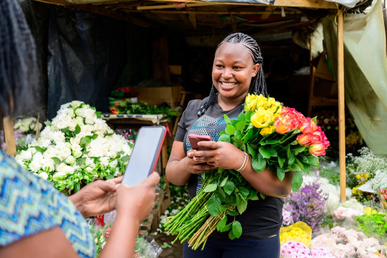 A woman holding flowers at a market