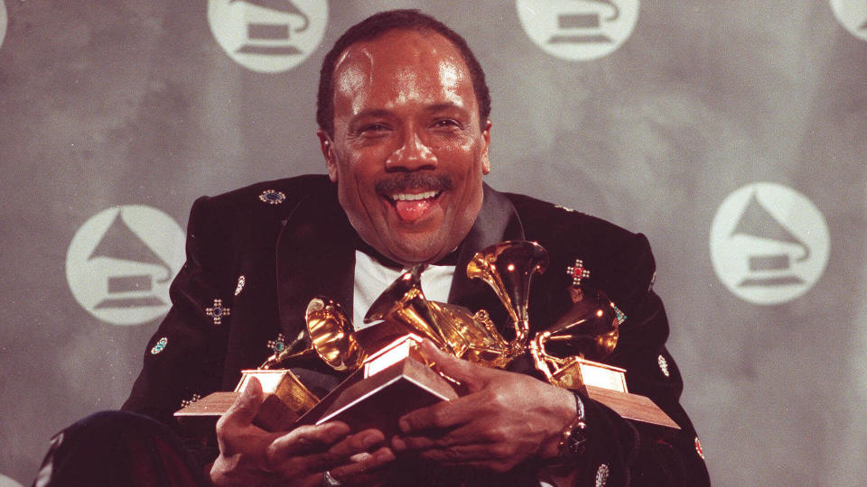 Quincy Jones cradles his Grammy awards,including the album of the year award, for his eclectic album 