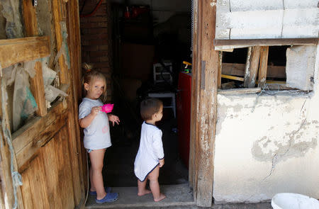 Two of Nikoletta Futo's four children are seen playing in Kanjiza, Serbia, July 7, 2017, after a grant from the Hungarian government enabled the family of six to purchase a house on the outskirts of the town. REUTERS/Bernadett Szabo