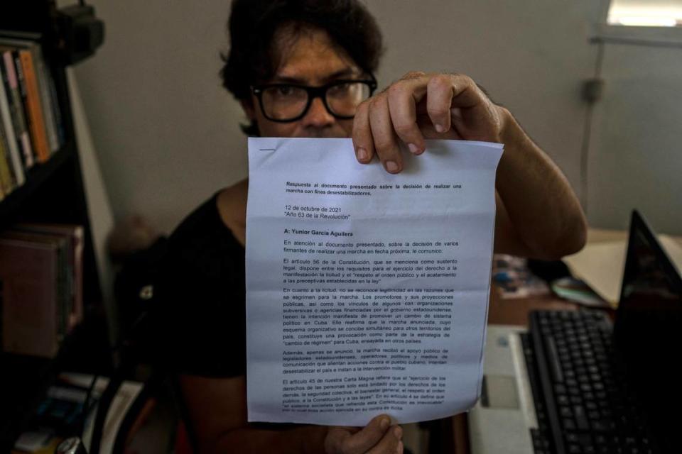 Yunior Garcia Aguilera, playwright and one of the organizers of a protest march, shows a response letter from the government denying them permission to march, during an interview with The Associated Press at his home in Havana, Cuba, Wednesday, Oct. 13, 2021.