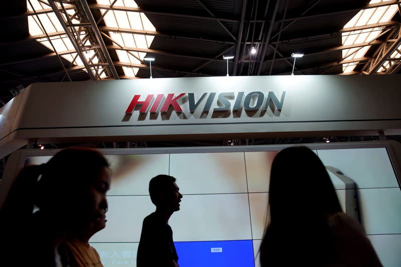 FILE PHOTO: People visit a HIKVision booth at the security exhibition in Shanghai