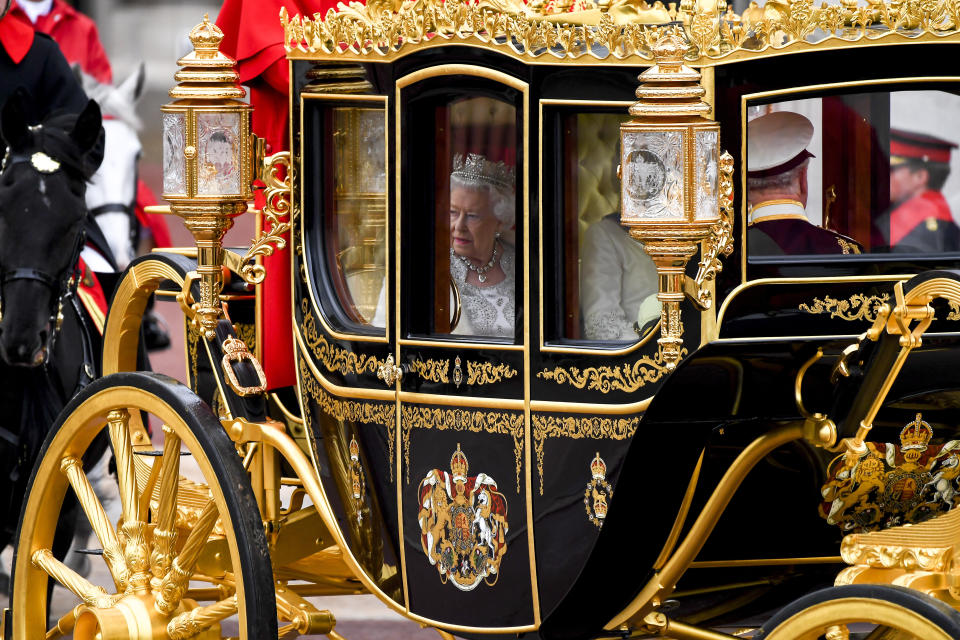Britain's Queen Elizabeth II travels in a carriage to parliament for the official State Opening of Parliament in London, Monday, Oct. 14, 2019. (AP Photo/Alberto Pezzali)