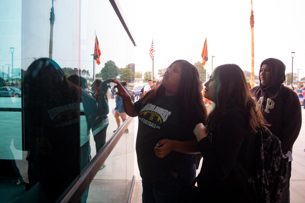 Denise Martinez, left, and Angely Mendoza search for their first classrooms on a list as they arrive for the first day of instruction at Del Sol High School in Oxnard in August.