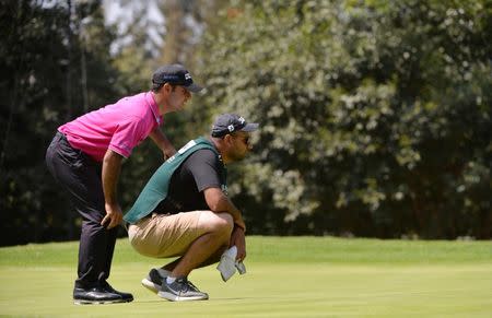 Mar 3, 2018; Mexico City, MEX; Shubhankar Sharma (left) and caddie Gurbaaz Mann lines up a putt on the fifth green during the third round of the WGC - Mexico Championship golf tournament at Club de Golf Chapultepec. Mandatory Credit: Orlando Ramirez-USA TODAY Sports