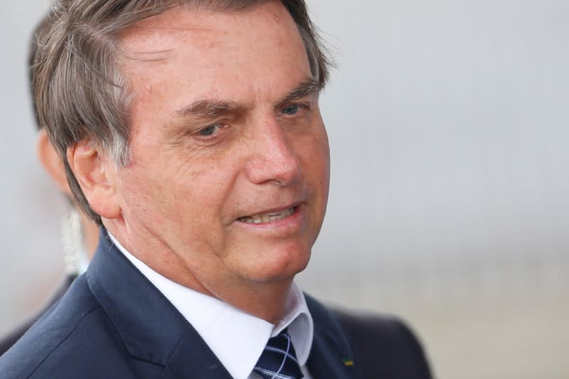 Brazil's President Jair Bolsonaro looks on as he leaves the Alvorada Palace in Brasilia