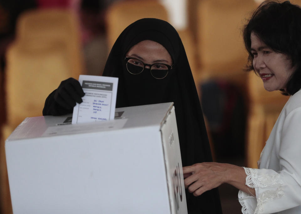 A Muslim woman casts her ballot during the election at a polling station in Jakarta, Indonesia, Wednesday, April 17, 2019. Voting is underway in Indonesia's presidential and legislative elections after a campaign that that pitted the moderate incumbent against an ultra-nationalist former general. (AP Photo/Dita Alangkara)