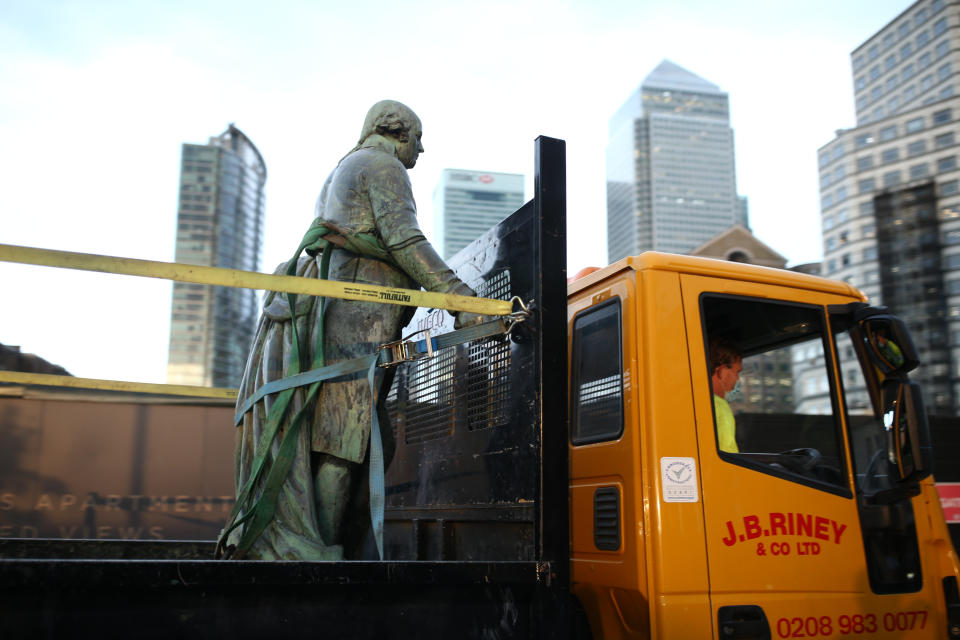 Workers take down a statue of slave owner Robert Milligan at West India Quay, east London as Labour councils across England and Wales will begin reviewing monuments and statues in their towns and cities, after a protest saw anti-racism campaigners tear down a statue of a slave trader in Bristol. (Photo by Yui Mok/PA Images via Getty Images)