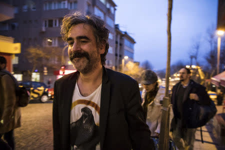 German-Turkish journalist Deniz Yucel and his wife, Dilek Mayaturk Yucel, are pictured in front of their home after Deniz Yucel was released from prison in Istanbul, Turkey, February 16, 2018. Depo Photos via REUTERS