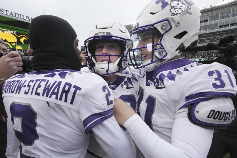 TCU place kicker Griffin Kell, center, celebrates with teammates Jordy Sandy (31) and Kee'Yon Stewart after Kell scored a field goal in the final seconds of an NCAA college football game against Baylor in Waco, Texas, Saturday, Nov. 19, 2022. TCU won 29-28. (AP Photo/LM Otero)