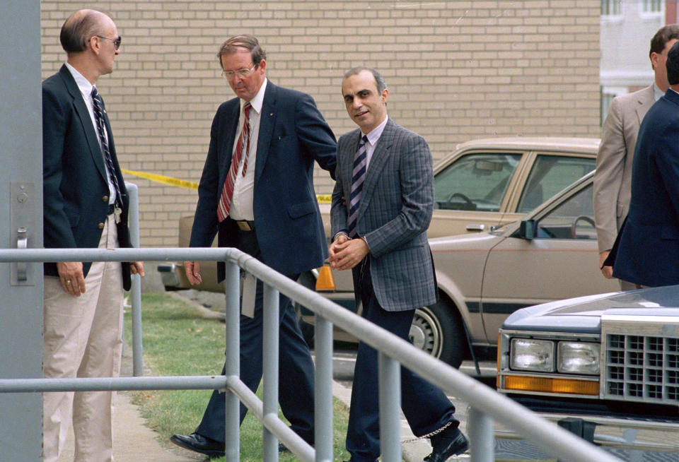 FILE - In this June 22, 1988 file photo, Walid Kabbani, right, one of three defendants of Lebanese descent from Montreal, Canada, is led into federal court in handcuffs in Burlington, Vt. Kabbani and the two others were caught smuggling the makings of a bomb into the U.S., on Oct. 23, 1987, in Richford, Vt. All three were convicted and sent to federal prison. (AP Photo/Toby Talbot, File)