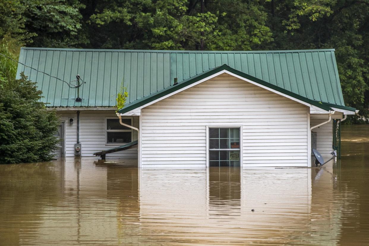 Homes are flooded by Lost Creek, Ky., on Thursday.