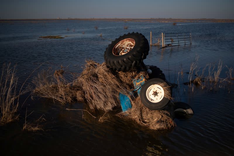 A tractor is seen submerged in flood waters in the aftermath of Hurricane Delta in Creole, Louisiana