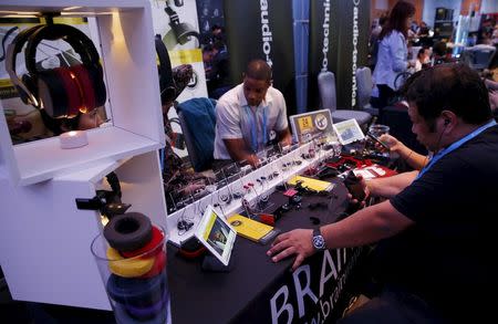 People test earphones and headphones during the CanJam headphone and personal audio expo in Singapore February 21, 2016. REUTERS/Edgar Su