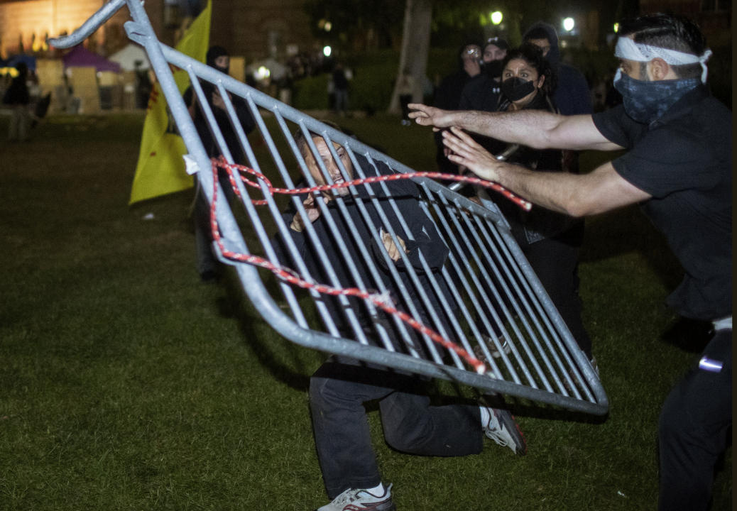 Demonstrators clash at a pro-Palestinian encampment at UCLA early Wednesday, May 1,  2024, in Los Angeles.  (Ethan Swope/AP)