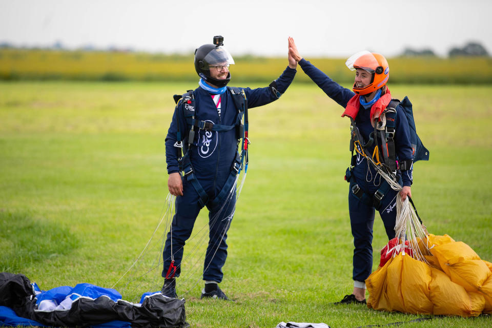 <p>EDITORIAL USE ONLY Professional skydivers, Emily Aucutt (right) and Josh Carratt officially set the Guinness World Record title for 'Most high and low fives by a pair in a single sky dive' at Langar Airfield in Nottingham, as Carex marks the final COVID-19 restrictions lifting today in England to show people how they can get out and about as safely as possible, by carrying sanitiser on the go. Issue date: Monday July 19, 2021.</p>
