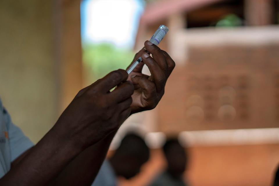 In this file photo taken Wednesday, Dec. 11, 2019, health officials prepare to vaccine residents of the Malawi village of Tomali, where young children become test subjects for the world's first vaccine against malaria.