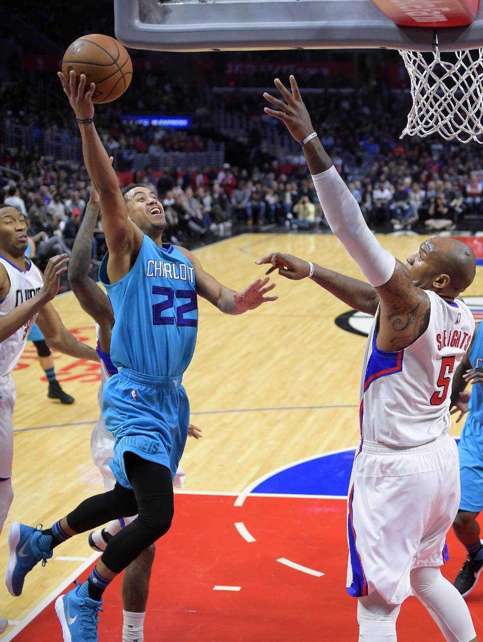 Charlotte Hornets guard Brian Roberts, left, shoots as Los Angeles Clippers center Marreese Speights defends during the first half of an NBA basketball game, Sunday, Feb. 26, 2017, in Los Angeles. (AP Photo/Mark J. Terrill)