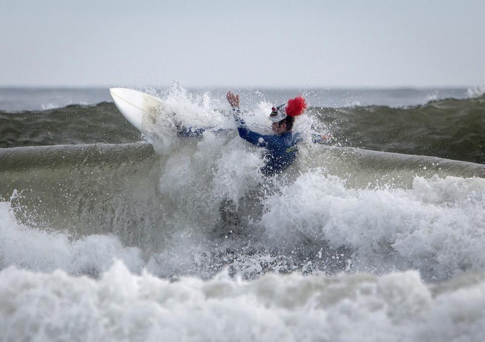 A participant surfs during the third annual Rockaway Halloween surf competition at Rockaway Beach in the Queens borough of New York